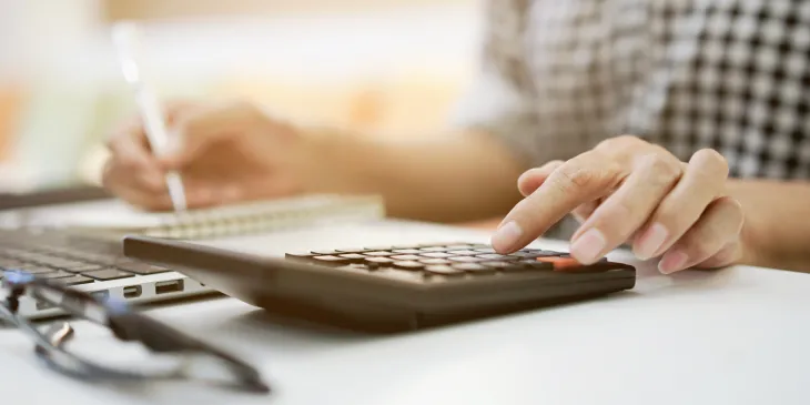 Woman using calculator