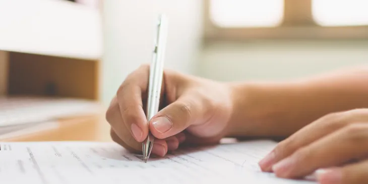 Person filling out documents