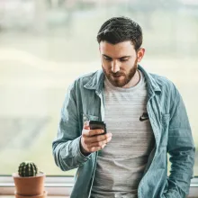 Man looking at mobile phone.