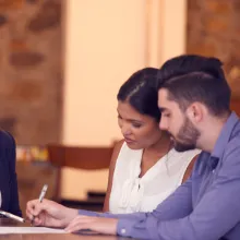 Young couple meeting with banker in office