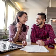 Couple happily having a conversation over paperwork