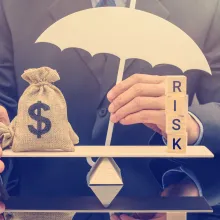 Man weighing money bag versus risk. 