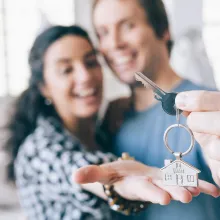 Couple holding keys to home