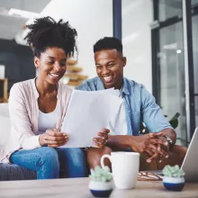 Smiling couple looking at paperwork