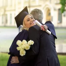 Graduate hugging father