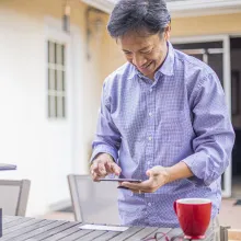 Man taking picture of check with his cell phone.