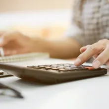 Woman using calculator