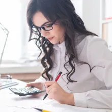 Woman using calculator