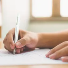 Person filling out documents