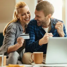 happy-couple-celebrating-while-using-credit-card-a-2023-02-24-19-17-08-utc.jpg